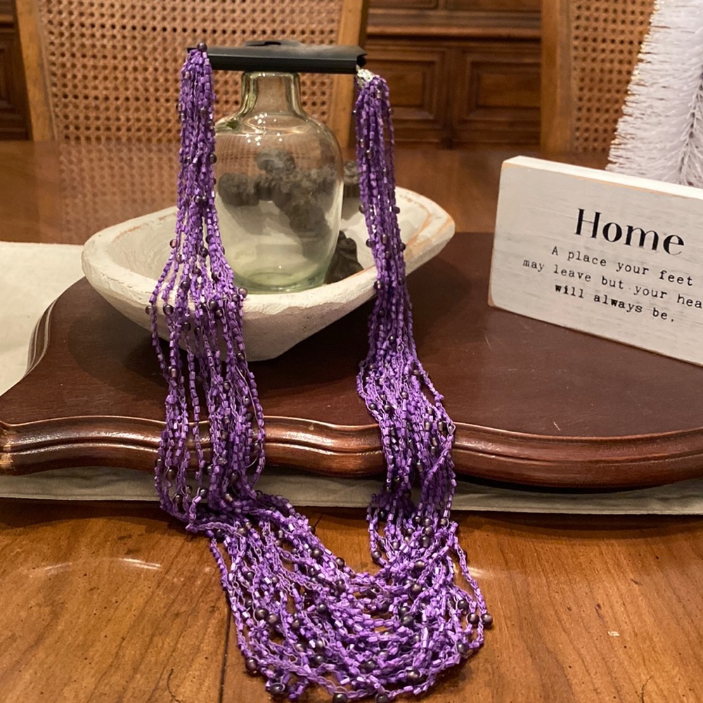 Substantial purple beaded mutual strand necklace